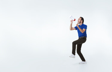 Asian delivery employee man shouting into megaphone making announcement isolated on white background. advertisement express delivery service concept.