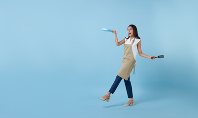 Entrepreneur Asian professional chief ready to cook, Chef holding spatula and frying pan isolated copy space on blue background.