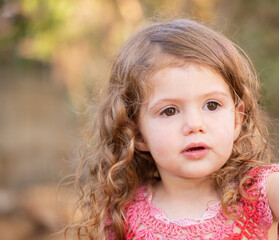 Little charming girl with curly hair