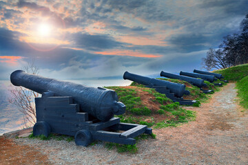 Artillery redoubt on the seashore. Cast iron ship medieval cannons.