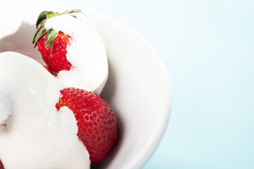 strawberries in cream, ripe red, juicy berries in milk yogurt, healthy dessert, natural breakfast