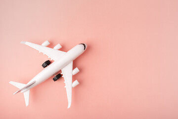 airline tickets booking, charter flights, low-cost airlines, air communication, travel, tourism and vacation, plane and on a pink background, copy space