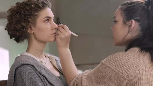 make-up artist makes models makeup