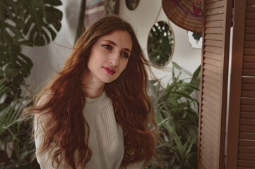 girl with long hair on the background of foliage