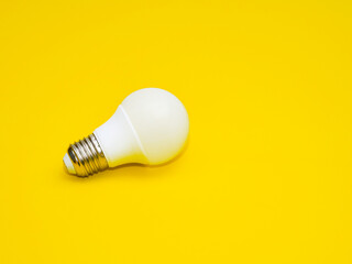 Light bulb isolated with yellow background.