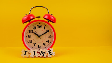 A red clock and jigsaw puzzle with text "TIME" isolated on a yellow background.
