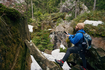 Young hiker checking the route on compass