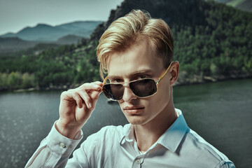 blond man by the lake