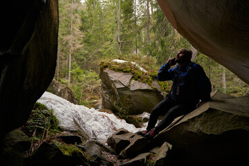 Obraz premium Tired male person resting while sitting on stone