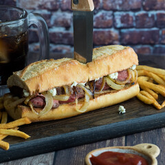 Freshly made steak hoagie bun with blue cheese and onions, served with fries.