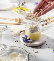 Set tools for homemade natural eco-friendly soy wax candles, wick, perfume, essential oil on a marble table. Making process. Trendy DIY. Craft hobby, small business, artisan products concept