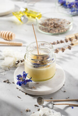 Set tools for homemade natural eco-friendly soy wax candles, wick, perfume, essential oil on a marble table. Making process. Trendy DIY. Craft hobby, small business, artisan products concept