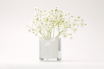 White flower bouquet in  vase on gray interior. Minimalist still life. Light and shadow nature horizontal background.