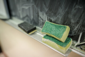 Shallow depth of field (selective focus) details with a sponge used for cleaning the blackboard...