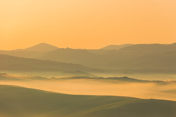 Sunrise with fog over a valley in Tuscany - Italy V