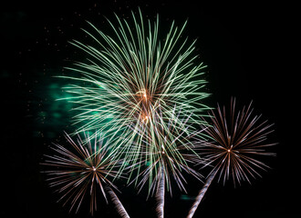 Festive fireworks. Bright rays of light against the black night sky.