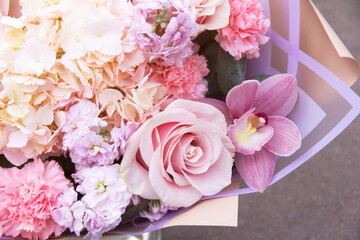 Floral, flowers backdrop, background. Purple violet pink bouquet with rose and orchid close-up in sunlight, details