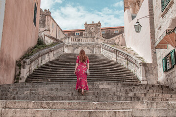 Fototapeta na wymiar Woman wandering around the streets of Dubrovnik.