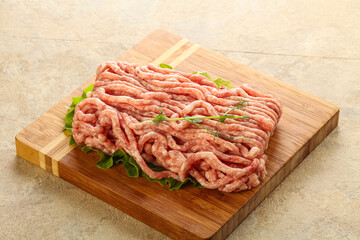 Raw minced pork meat over board