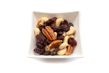 A white bowl with dried fruits and nuts, isolated on white background.Dried fruits are so called because they all have one characteristic in common:they have less than 50% water.
