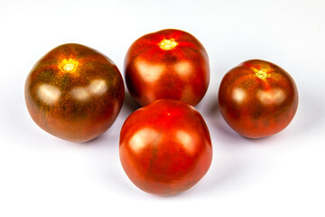 Four ripe tomatoes of a black grade 