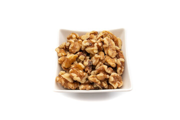 A white bowl with nuts. Isolated on white background. Nuts are available in two forms, shell or shelled, and can be whole, halved, or in smaller portions due to processing. 