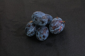 Ripe plum heap over background