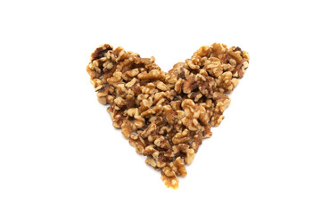 A handful of walnuts in the shape of a heart. Isolated on white background. Nuts are available in two forms, shell or shelled, and can be whole, halved, or in smaller portions due to processing.
