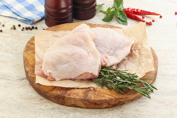 Raw chicken thighs over board