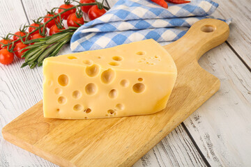 Maasdam cheese piece over board