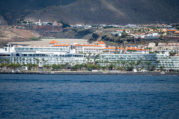 Fototapeta na wymiar View on resorts and beaches of South coast of Tenerife island during sail boat trip along coastline, Canary islands, Spain