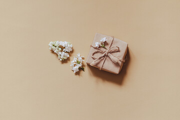 lilac flowers with eco gift box from kraft paper. Creative congratulations layout. Spring flower concept.