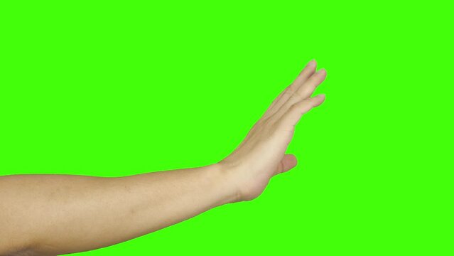 man's hand waving bye meaning goodbye on a green background