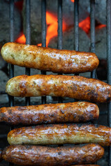 german sausage "bratwurst" on the grill with flame