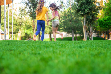 Fototapeta premium Children's feet go on the grass. Selective focus.