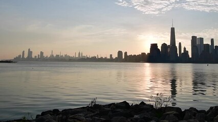 Silhouette skyline of NYC taken from Liberty State Park during morning sunrise, city park, travel tourism theme, NJ park