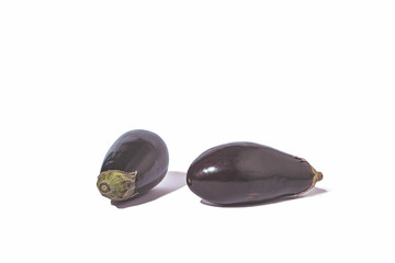 Whole aubergines on white background