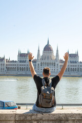 Fototapeta premium man traveler in front of Budapest parliament building