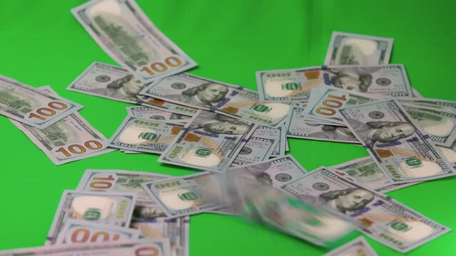 Short film showing dollar's banknotes falling on green background. Economy cash money concept. Sweden. 