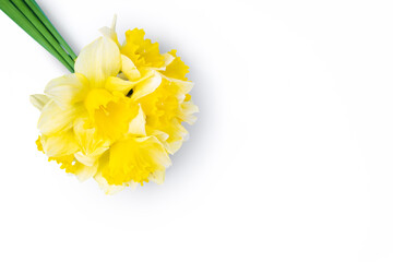 Bouquet of yellow daffodils, narcissus isolated on white background with copy space. Mockup, template for holiday, birthday, mother's day on yellow background, copy space for text. Top view, flat lay.