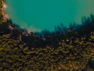 Fototapeta na wymiar aerial view of lake with blue water near forest