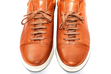 Men's youth leather shoes of brown color with a white sole on a white background.