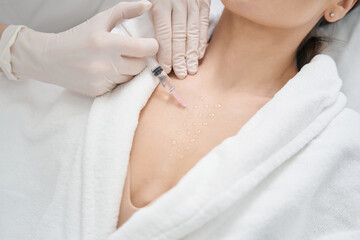 Woman receiving rejuvenating injection in beauty salon