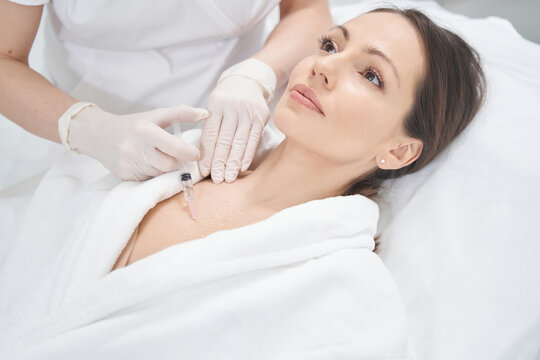 Woman having rejuvenating injections procedure in beauty clinic