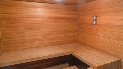 Traditional finnish sauna made from wood. Empty interior of wooden spa cabin with hot dry steam.