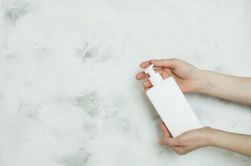 Female hands with cosmetic bottle