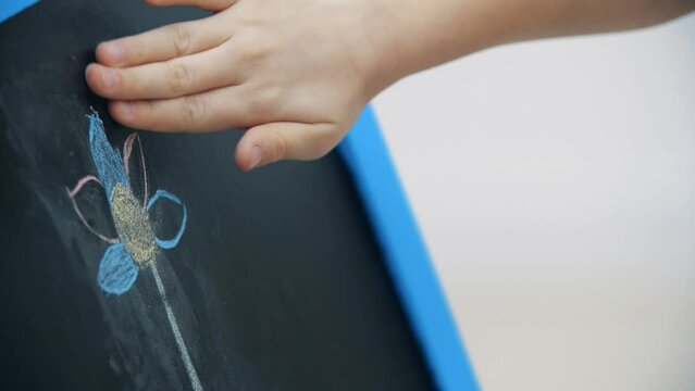 4k slowmotion video of white board and kid hand drawing.