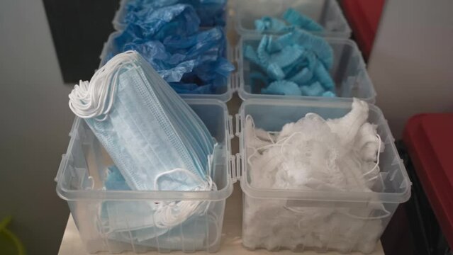 personal protective equipment PPE: hairnet, surgical mask and blue shoe covers