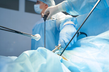 Surgery specialist bringing gauze to abdomen incision