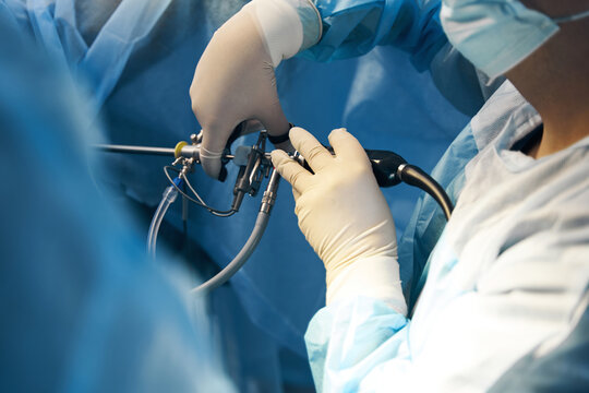 Hand of surgeon holding laparoscopic equipment for minimally invasive surgery